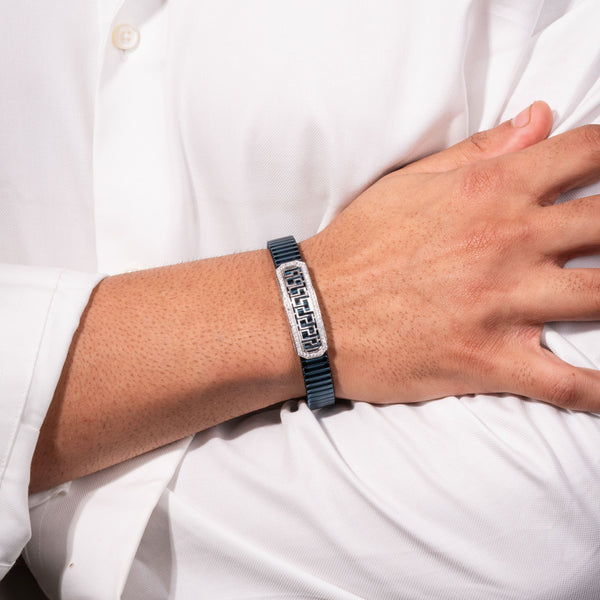 Person wearing a bracelet with text on a white shirt background